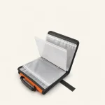 Open tackle binder showing clear storage sleeves, metal binder rings and a black-edged cover