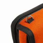 Close-up of an orange tackle binder showing woven texture, black trim, a metal ring and webbing