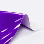 Curved purple gloss film sheet showing its pale underside