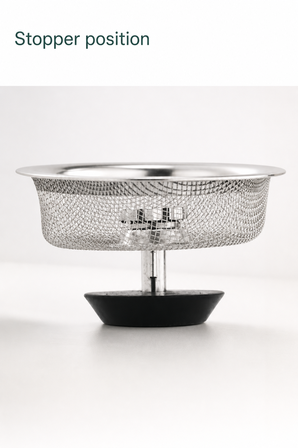 Side view of the basket in the stopper position, with its centre knob low inside the mesh basket