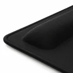 Close-up of the black pad showing its raised cushion, fabric texture and stitched outer edge