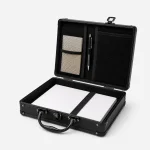 Open document case with papers under an interior strap and mesh pockets inside the lid