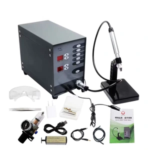 Jewelry pulse arc welding machine with its pen, black stand and pictured accessory kit on a white background