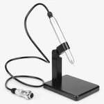 Silver welding pen in an upright black holder with its cable and round connector on a light gray background