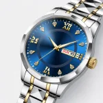 Close-up of a blue watch dial with gold-tone hands and a day-and-date window.