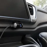 Mini caméra automobile montrée sous un écran de tableau de bord, avec un câble vers le côté