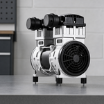 Oil-free pump motor assembly displayed on a workshop bench