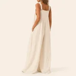 Rear view of a light jumpsuit with broad straps, a low straight back and wide legs