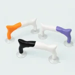 Orange-white, purple-white and black-white ruler handles arranged with clear suction cups visible