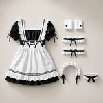 Eight-piece black and white costume laid flat with the dress and apron, two wrist cuffs, two garters, a headband and a neckband.