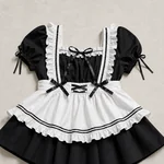 Flat-lay close-up of the square ruffled neckline, ribbon bows, puff sleeves and white apron with double black trim.