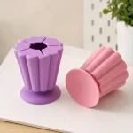 Purple collector beside a pink collector turned on its side to show the round base