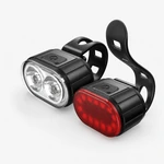 Coppia di luci anteriore bianca e posteriore rossa con pulsanti superiori neri e fascette su grigio chiaro.