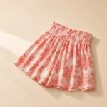 Angled flat view of coral and white floral shorts with a gathered high waistband
