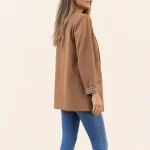 Side and rear view of a camel long blazer with a plain back and leopard-pattern cuff