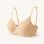 Angled view of a beige bra showing the cup shape, side band and shoulder straps