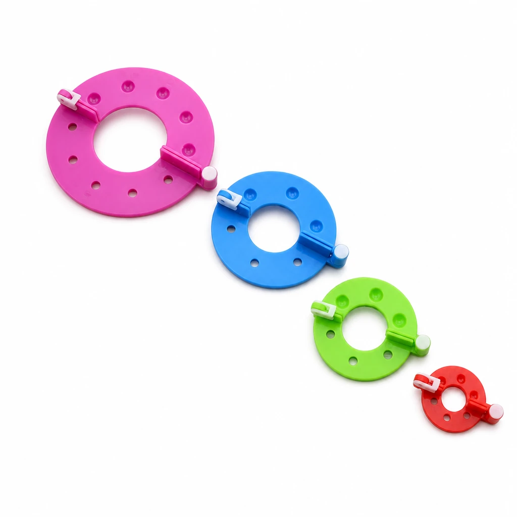 Four plastic pom-pom makers in different sizes and example colors, without yarn or scissors
