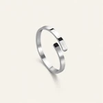 Steel-color ring viewed from an elevated side angle on a light background