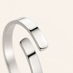 Close view of the steel-color ring’s two offset ends and opening