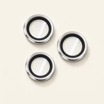 Three silver metal-rim camera lens protector rings arranged in a triangle on a light background.