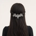 Style 05 bat clip across gathered dark hair, rear view