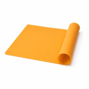 Orange silicone craft mat with one end rolled on a white background