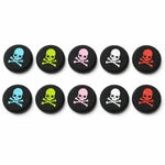 Ten black thumbstick caps with colored skull prints arranged in two rows of five