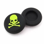 Two silicone caps showing a lime-green skull top and a plain black underside