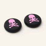 Two pink skull-print silicone caps shown at an angled view