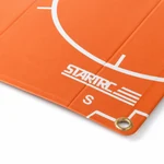 Close-up of the orange pad corner with STARTRC print, landing markings and a metal eyelet