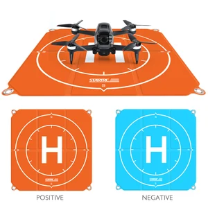 Original image with a drone on an orange pad and orange and blue pad views below; drone not included