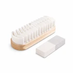 Suede cleaning brush with a pale wooden base and white wavy fins beside a two-tone rectangular eraser