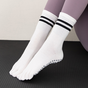 White five-toe socks worn as a pair with black stripes and sole dots