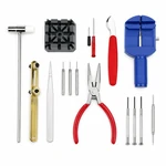 Sixteen watch repair tools arranged in a flat lay