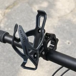 Black EasyDo ED-031 cage and clamp mounted on a bicycle handlebar outdoors, cage empty