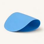 One blue round silicone gripper pad shown gently curved on white.