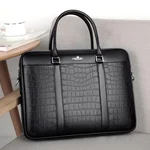Black briefcase upright beside a small table, top handles visible