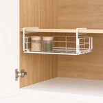 White wire basket hanging below a wooden cabinet shelf with two small pantry jars inside