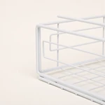 Close-up of the white basket side showing its wire frame, raised arm and grid base