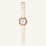 White-strap watch showing its analog dial on a cream background