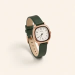 Green-strap watch with white dial on a cream background