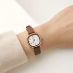Brown-strap watch worn alone on an adult wrist