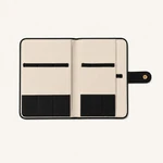 Open watch strap organizer with a pale interior, black lower pockets and horizontal retaining bands