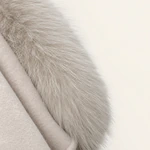Close-up of pale fur beside the wool coat fabric