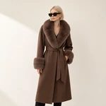 Woman wearing a brown belted coat with fur trim
