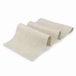 Beige linen couche arranged in raised folds with its overlocked edge visible
